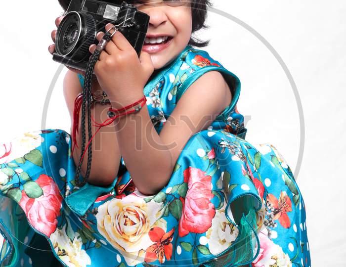 A cute girl is clicking photoshoot
