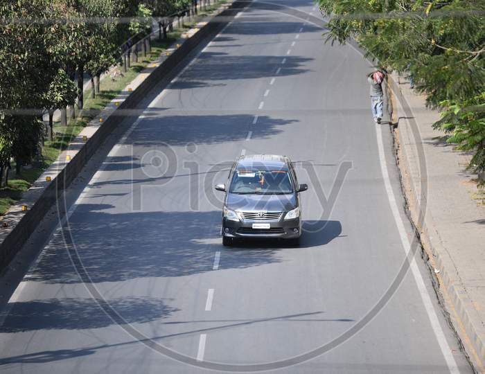 a car moves on JNTU-Hitech City main road amid nationwide 21 day lockdown due to coronavirus pandemic