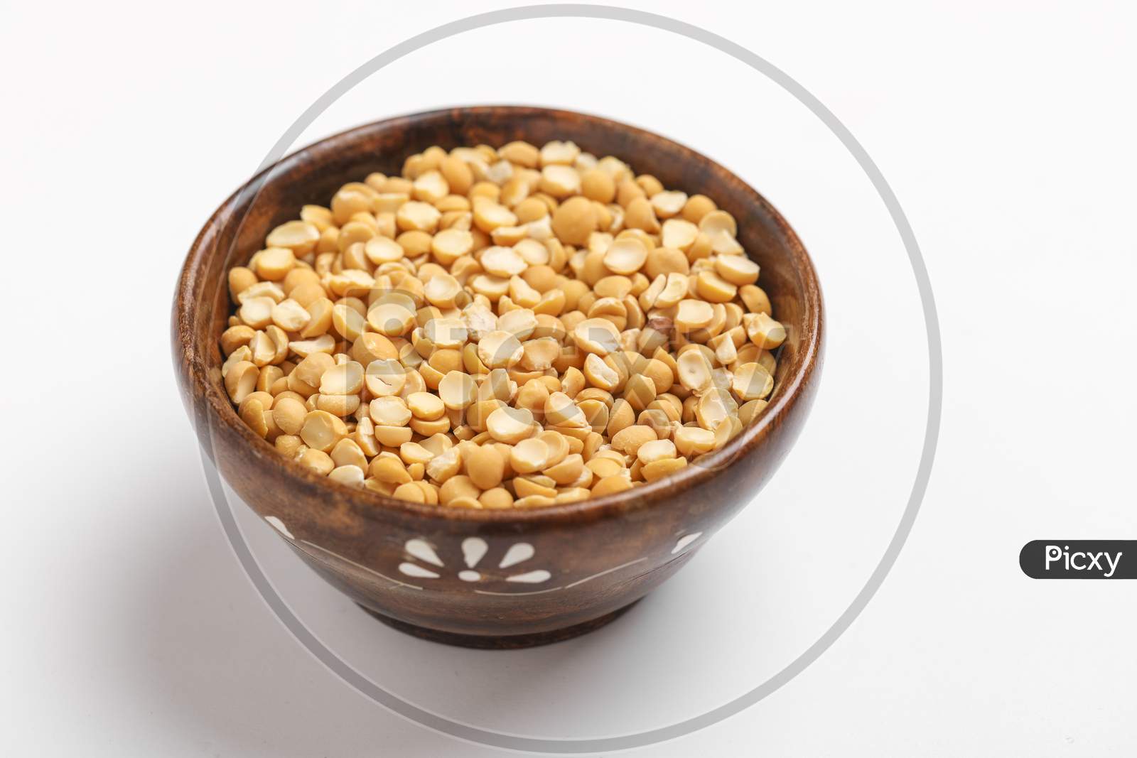 Dried Chickpea Lentils In Wooden Bowl On White Background , Split Chickpea Also Know As Chana Dal ,