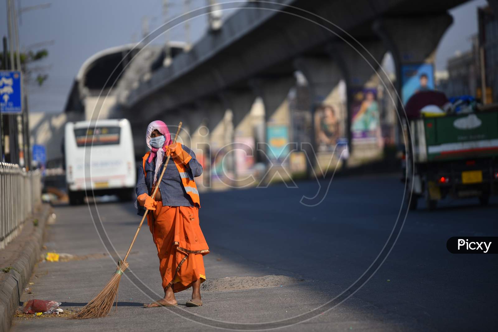 GHMC Sanitation worker cleaning road as the wears a protective mask during lockdown amid coronavirus pandemic