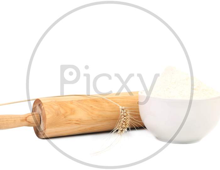 Composition Of Roll Pin And Wheat Flour. Isolated On A White Background.