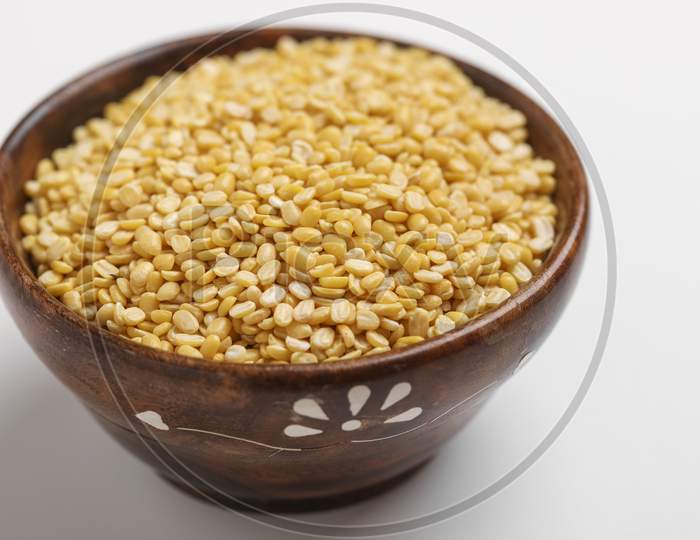 Yellow Moong Mung Dal Lentil Pulse Bean In Wooden Bowl On White Background ,
