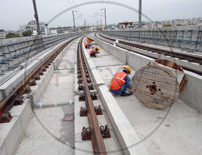 Construction Workers Working at Under Construction Metro Tracks And Metro Stations In Hyderabad