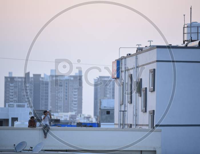 People sitting on their rooftops in the evenings to watch sunset to tackle the boredom due to the lockdown amid coronavirus outbreak