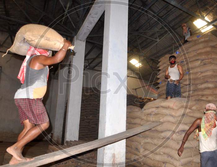 Laborers Carry Sacks Of Rice After Unloading Them from a Wagon Train At Food Corporation of India(FCI) Godown During a national Wide Lock Down In Wake Of Corona Virus (COVID-19) Pandemic  in Guwahati, April  20,2020