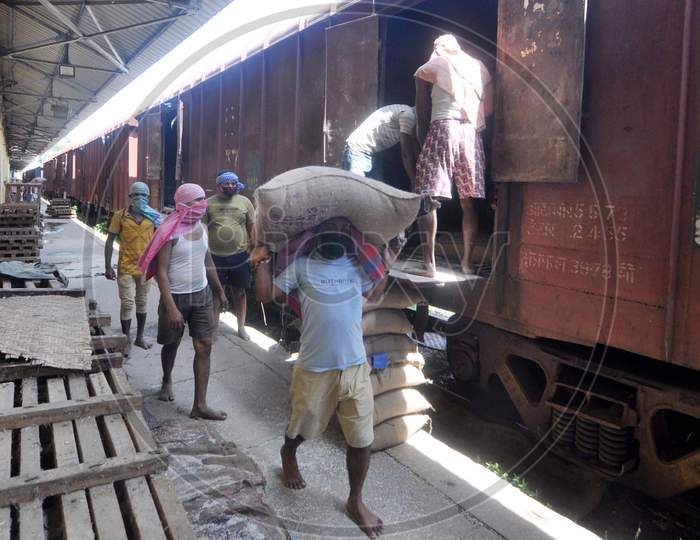 Laborers Unloading Rice bags Or Sacks From a Goods Train At Food Corporation Of India(FCI)  Godown  During Corona Virus ( COVID-19) Lockdown in Guwahati , April 20,2020