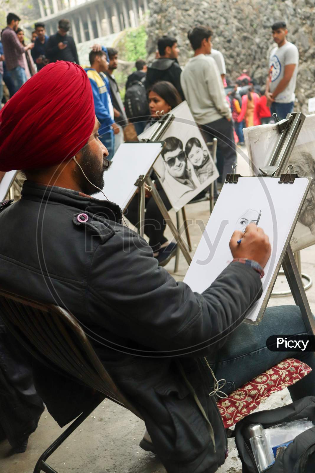 A Punjabi Boy Drawing A Sketch Of Beautiful Girl On White Paper With Pencil At Rock Garden, Uttar Marg, Rock Garden Of Chandigarh, Sector 1, Chandigarh