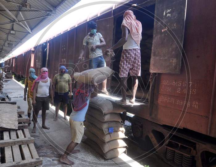 Laborers Unloading Rice bags Or Sacks From a Goods Train At Food Corporation Of India(FCI)  Godown  During Corona Virus ( COVID-19) Lockdown in Guwahati , April 20,2020