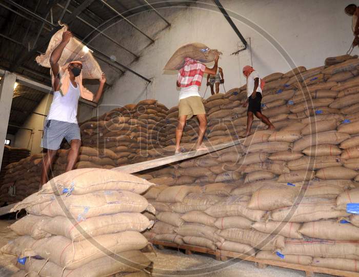 Laborers Carry Sacks Of Rice After Unloading Them from a Wagon Train At Food Corporation of India(FCI) Godown During a national Wide Lock Down In Wake Of Corona Virus (COVID-19) Pandemic  in Guwahati, April  20,2020