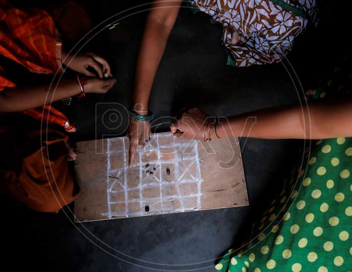 Indian House Wives Playing Traditional Indian Board Games In Houses During Corona Virus ( COVID-19)  Lockdown
