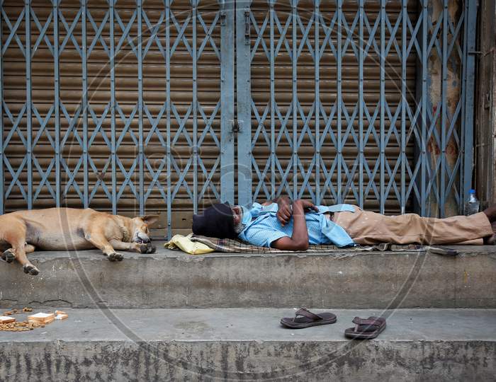A Homeless Man Sleeping On Road side During Lockdown period For Corona Virus or COVID-19 Pandemic in Bangalore City