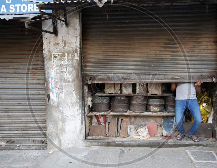 A Flour Mill Shopkeeper Closing Shop Shutter As per Lockdown Rules During Corona Virus ( COVID-19) Pandemic In Bangalore City