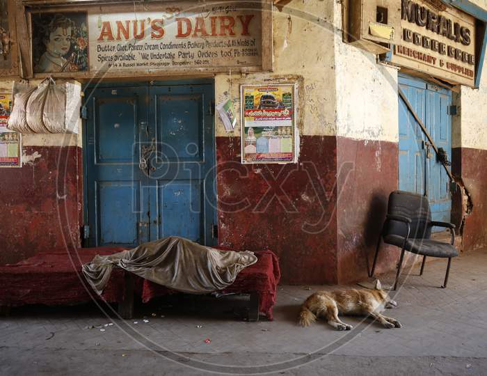 A Dairy product vendor Sleeping At a Shop Door During Lockdown for Corona Virus Or COVID-19 Pandemic in Bangalore