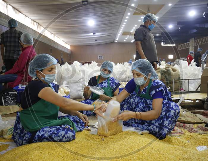 Workers  Packing Groceries Packets For Distribution For Poor People In Bangalore City During Corona Virus Or COVID-19 Pandemic