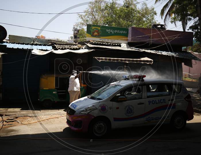 A Bangalore City Police Car Being Sprayed With Disinfectant For Corona Virus or COVID-19 Pandemic. Banaglore