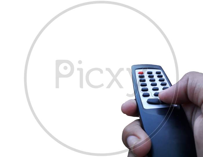 A man holding the TV remote in his hand and pressing its button isolated image in white background
