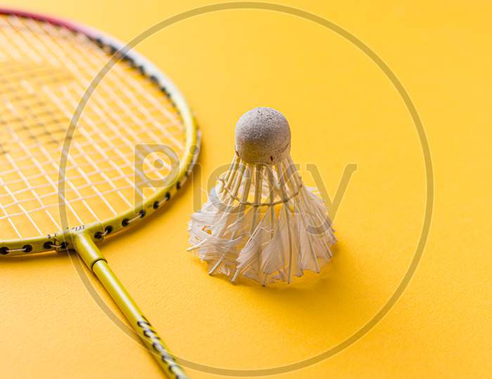 Badminton racket and white feather shuttle with stock isolated image.