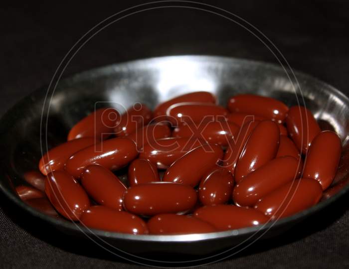 Capsules Or Pills On a Grey Surface