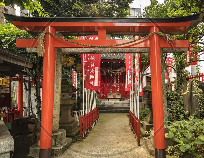 Torii gate of small Shinto Santuary dedicated to the Uga-no-Mitama divinity meaning "the spirit of the rice in storehouses" which is associated with food and agriculture and which is often represented in the form of the fox Inari the divinity of rice.