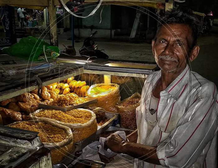 The old shopkeeper selling sweets