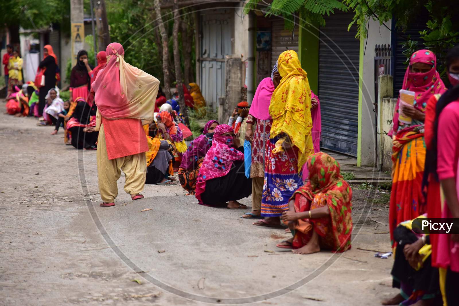 Women Wait For Their Turn To Collect 500 Indian Rupees  From A Bank'S Customer Service Point   During A Nationwide Lockdown In The Wake Of Corona virus (COVID-19) Pandemic,  In Nagaon District Of Assam On  Tuesday, April 21, 2020.