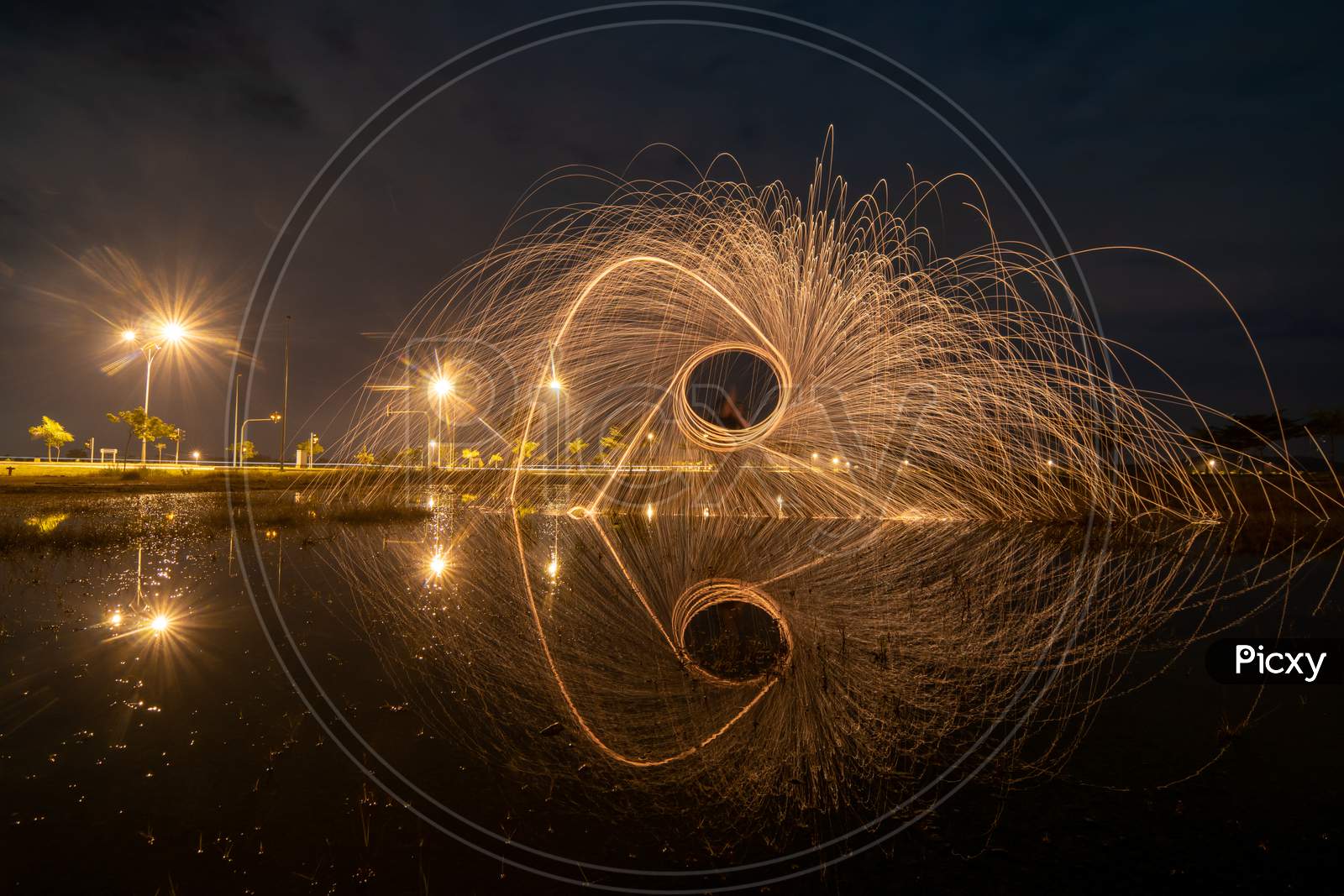 Burning Of Steel Wool Reflection In Water.