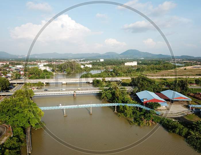 Aerial View Pedestrian, Vehicle And Train Cross Over The River At Nibong Tebal.