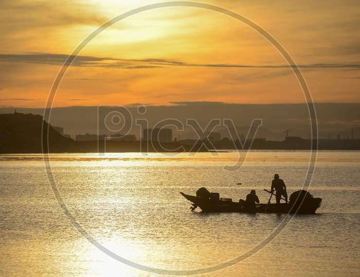 Silhouette Fisherman Fishing In Sea In Morning.