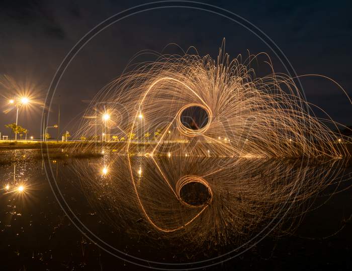 Burning Of Steel Wool Reflection In Water.