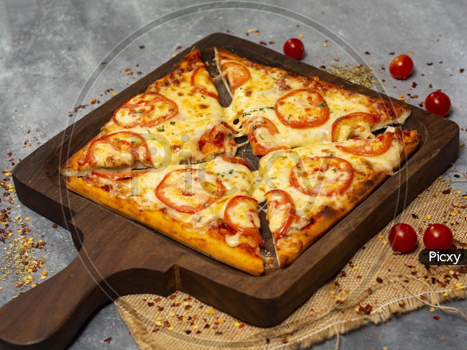 Square shaped margherita pizza on wooden pan