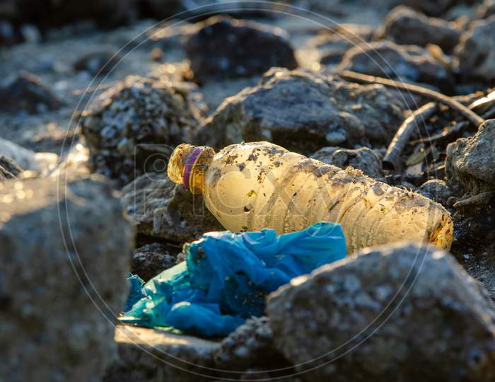 Plastic Bottle At Rock. Plastic Contamination