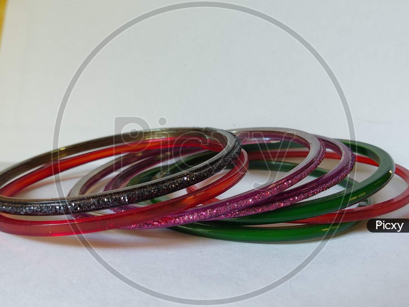 Colorful bangles on plain background. Glass bangles on white background. Bangles with close view.
