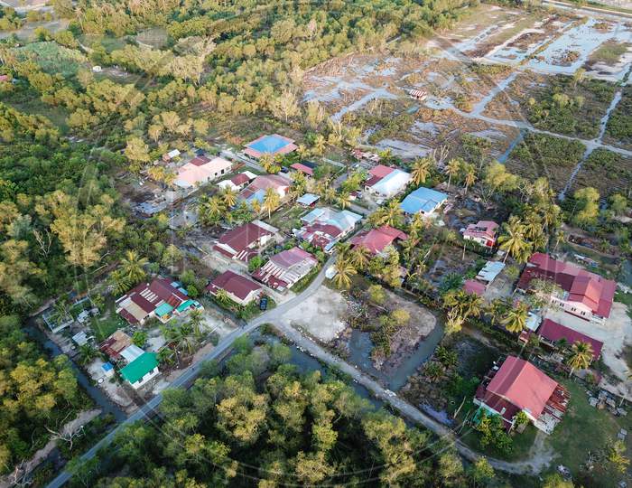 Aerial View Kampung House Near Green Field.