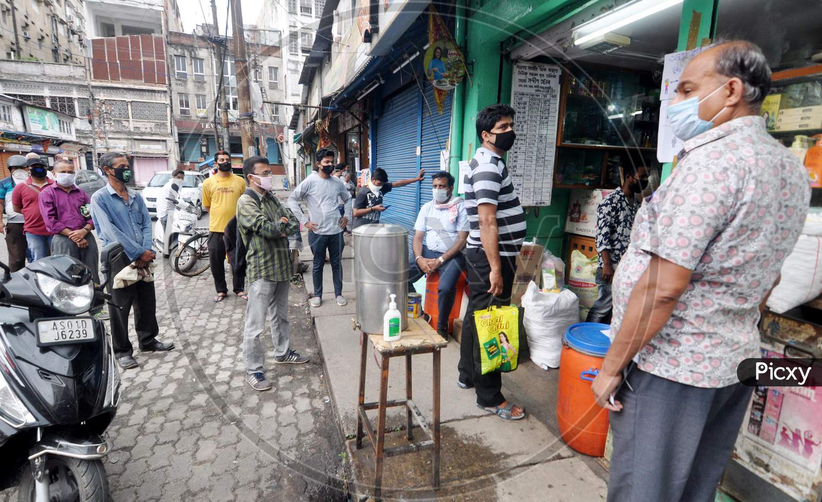 People Standing At Safe Distances In A Queue To Buy  Food Items During The Nationwide Lockdown Imposed In Wake Of Coronavirus Pandemic, In Guwahati On April 22, 2020