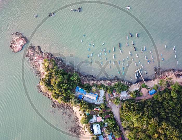 Aerial Fishing Village Near The Rock Sand Coastal At Pulau Sayak.