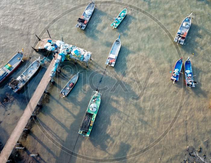 Aerial View Look Down Fishing Jetty In Evening.