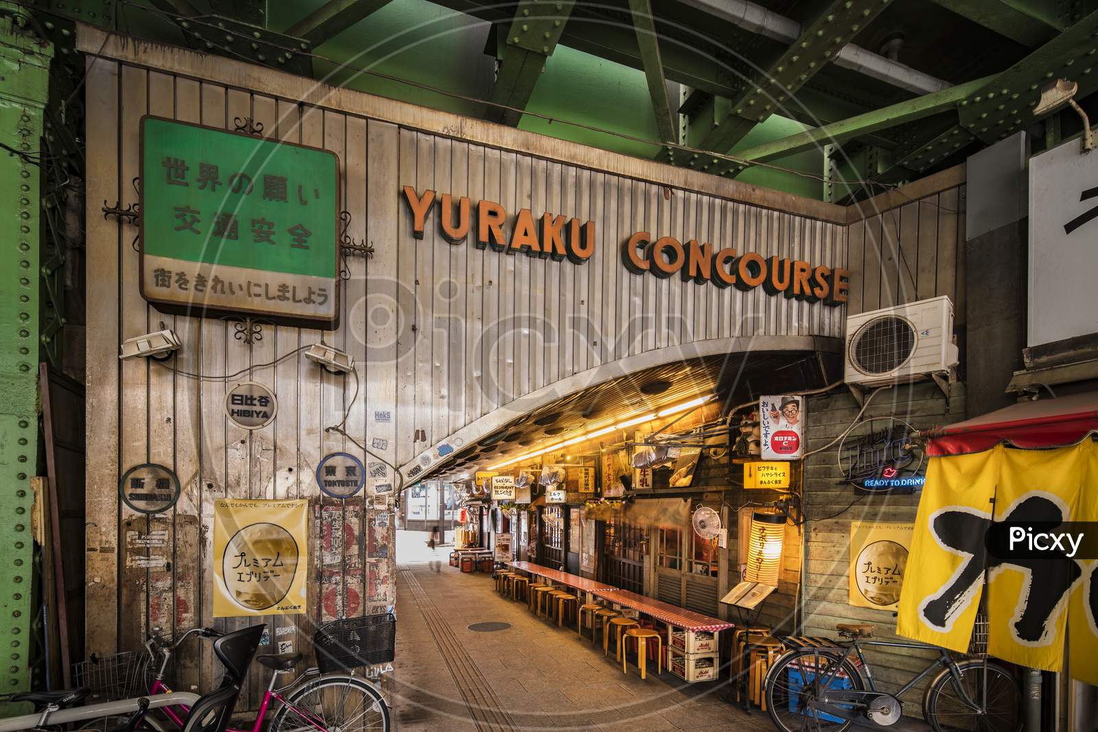 Underpass Yurakucho Concourse Under The Railway Line Of The Station Yurakucho. Japanese Noodle Stalls And Sake Bars Revive The Nostalgic Years Of Showa Air With Old Posters And Placards Glued To The Walls Of The Tunnel.