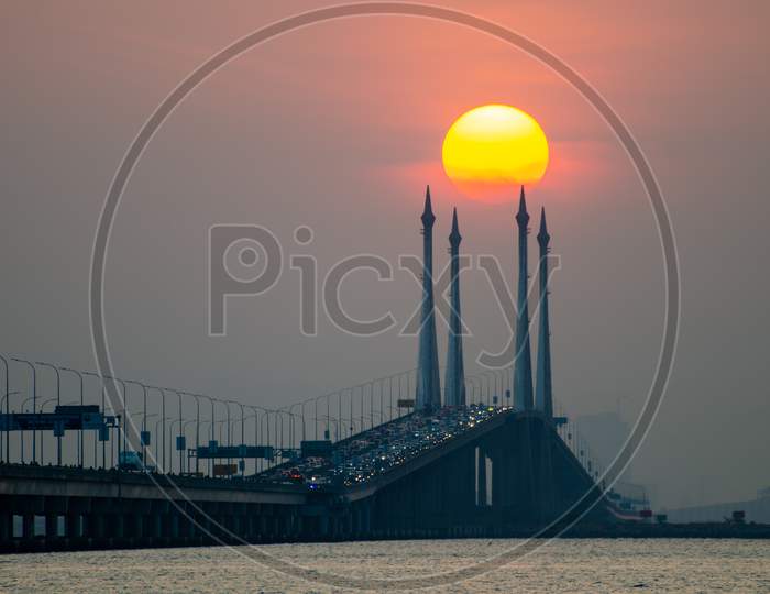 Egg Yolk Sunrise At Penang Bridge During Hazy Morning.