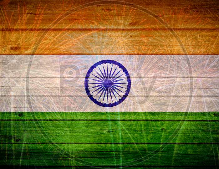 Indian flag painted on wooden texture with fireworks background