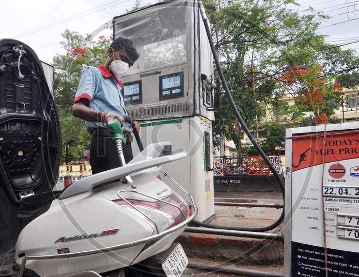 A Worker Re-filling a scooty At A Petrol Station During A Nationwide Lockdown Amidst COVID-19 or Coronavirus Outbreak  In Guwahati On April 22, 2020
