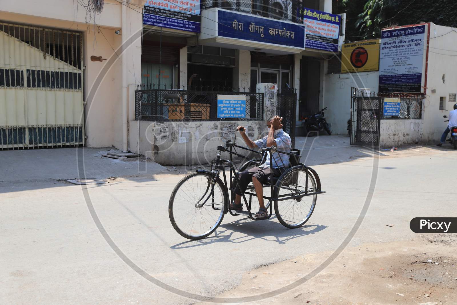 A Physically Challenged Man Rides a Tricycle On Empty Streets During Nationwide Lockdown Amidst Coronavirus Or COVID-19 Outbreak in Prayagraj