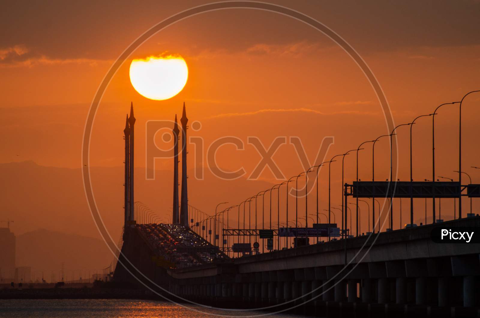 Silhouette Egg Yolk Sun Over Penang Bridge.