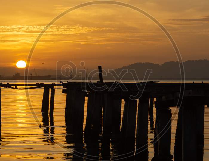 Beautiful Sunrise Over The Sea Near The Wooden Bridge At Fisherman Jetty Penang, Malaysia.