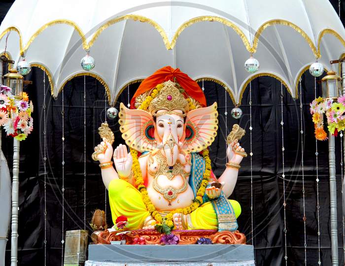 Colorful Painted Handcrafted Statue Of Indian Hindu Lord God Idol Ganesha.Ganpati Made Of Earthenware Mud Clay Stone Or Rock For Worship Pooja In Deepawali, Diwali And Ganesh Chaturthi Festival.