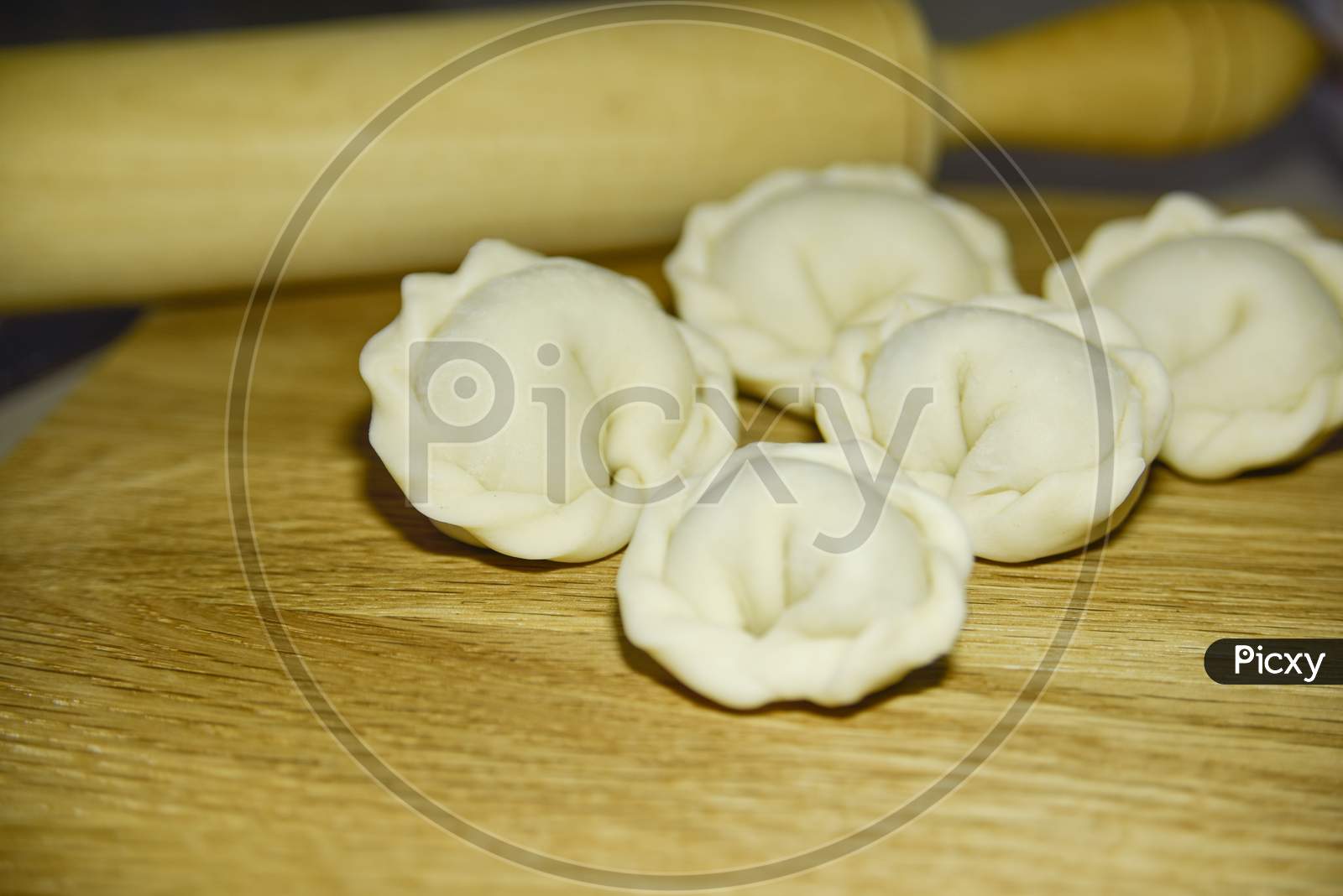 Five Dumplings Of Round Shape On The Wooden Deck. Selective Focus. Close-Up Look.