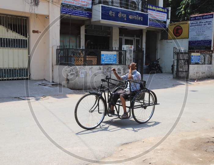 A Physically Challenged Man Rides a Tricycle On Empty Streets During Nationwide Lockdown Amidst Coronavirus Or COVID-19 Outbreak in Prayagraj