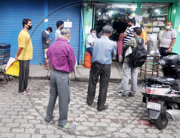 People Standing At Safe Distances In A Queue To Buy  Food Items During The Nationwide Lockdown Imposed In Wake Of Coronavirus Pandemic, In Guwahati On April 22, 2020