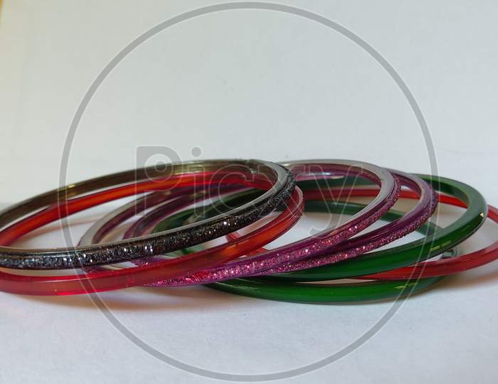 Colorful bangles on plain background. Glass bangles on white background. Bangles with close view.