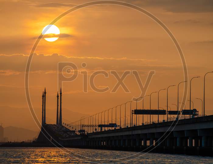 Silhouette Sunrise Over Penang Bridge.