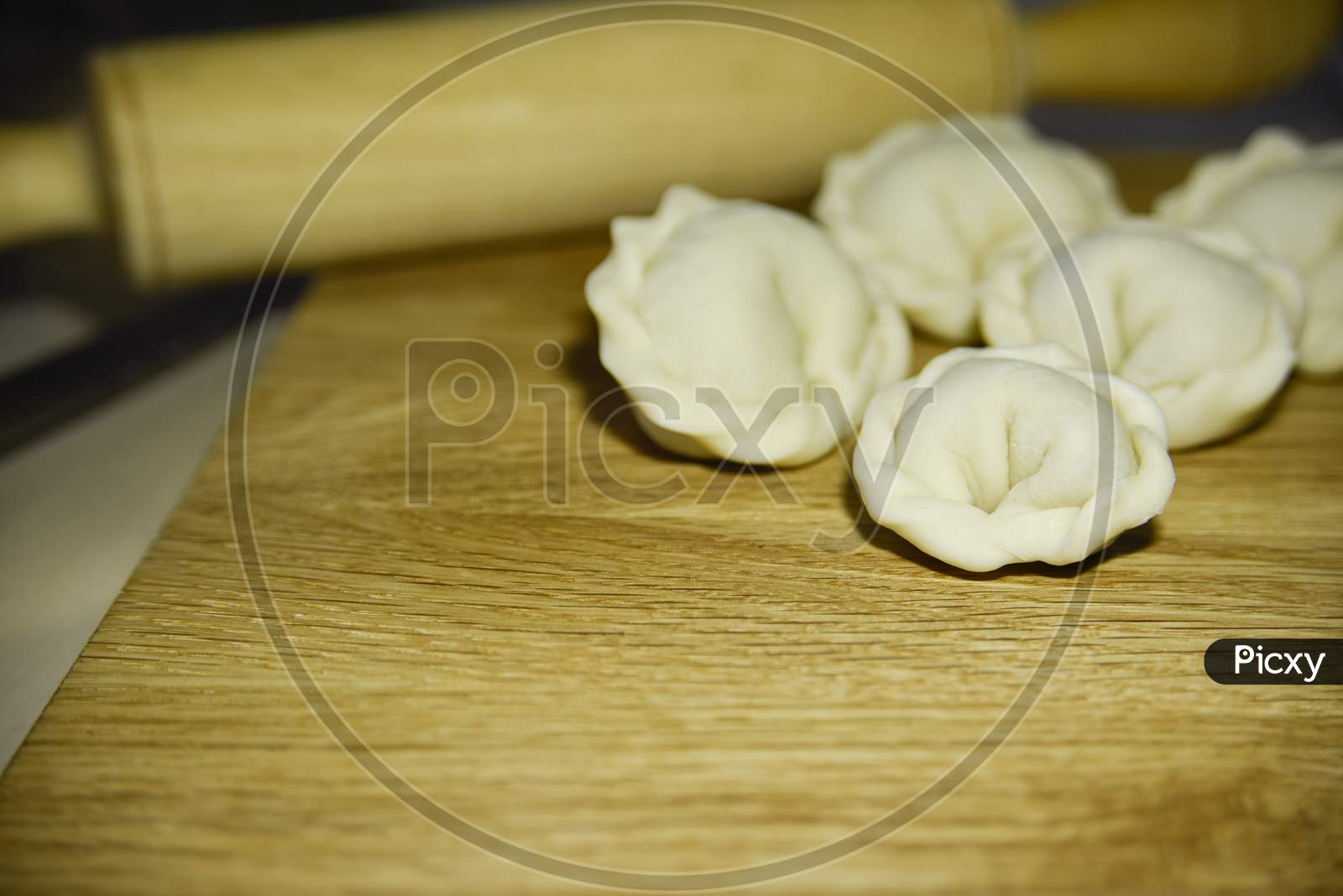 Five Dumplings Of Round Shape On The Wooden Deck. Selective Focus.